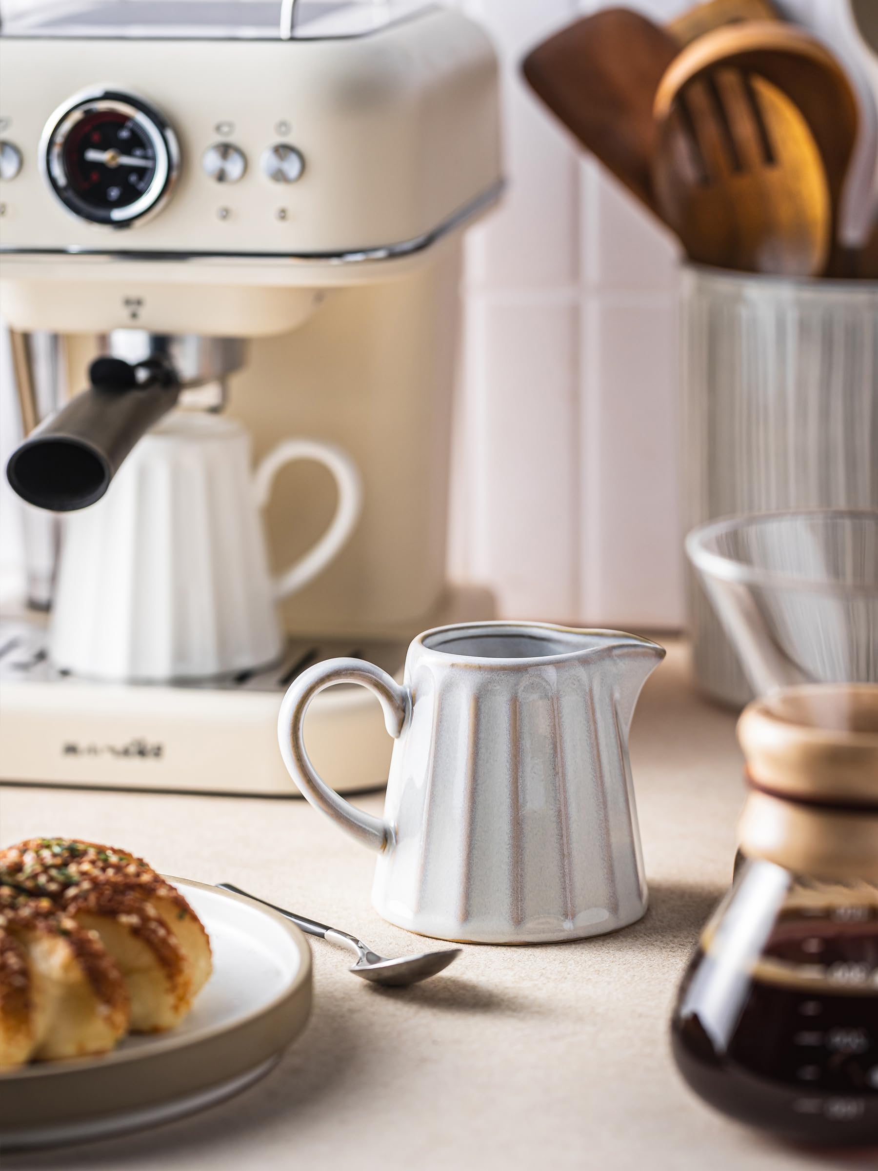 YHOJOY ceramic creamer pitcher with an easy-grip handle for comfortable pouring.