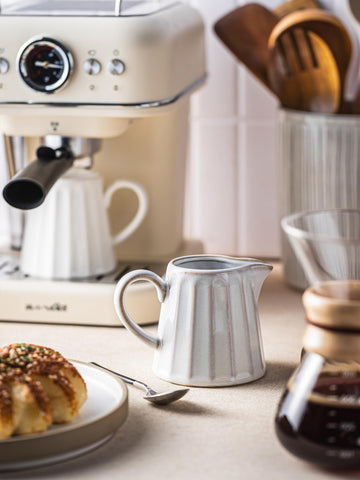 YHOJOY ceramic creamer pitcher with an easy-grip handle for comfortable pouring.