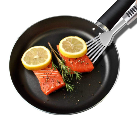 YK GDYORKITCHEN Premium Fish Spatula shown in-pan for easy grilling and turning.