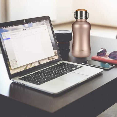 YOHKOH mini bottle on desk with water glow emphasizes usability.