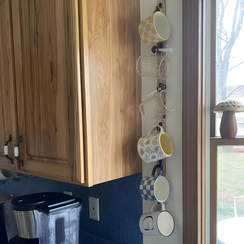 Yohsnor wall-mounted rack adds warm wood tones to any space for coffee cups.