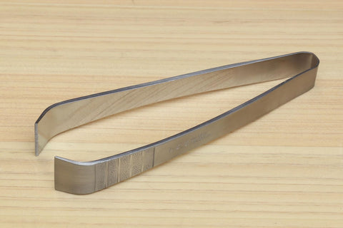 Yoshihiro garnishing tweezer in sushi prep demonstrates precise handling for plates