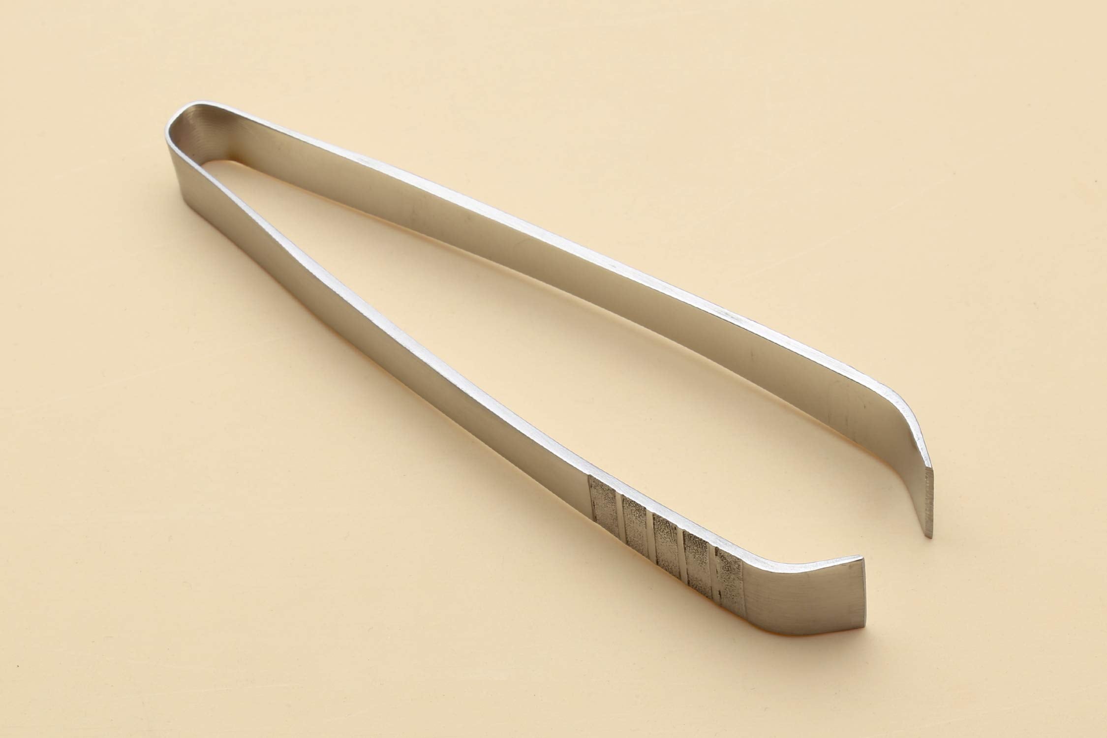 Yoshihiro non-slip fish bone tweezer tip close-up shows secure grip for delicate work