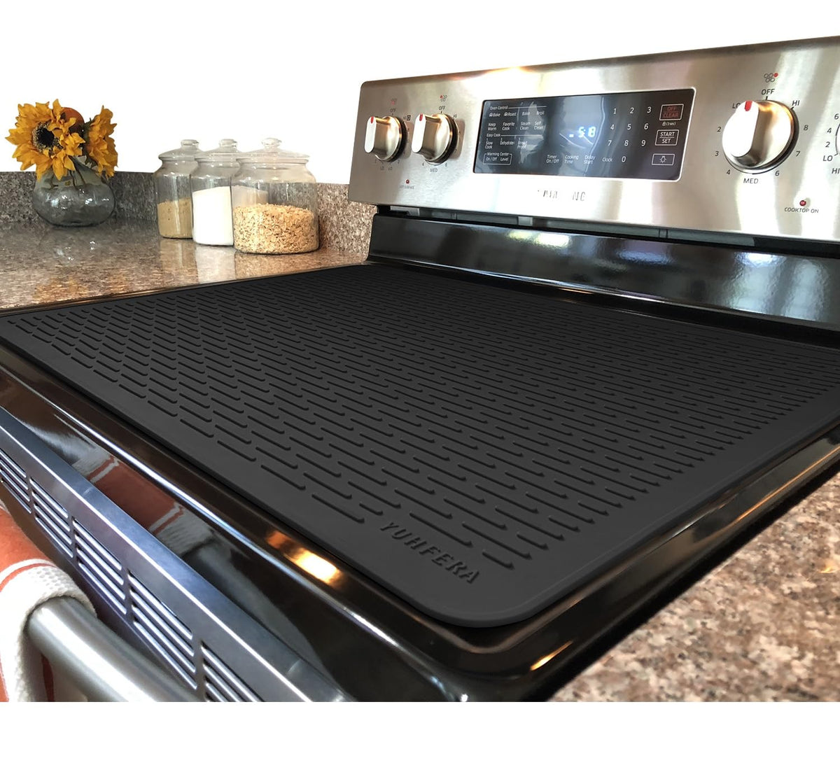 YUHFERA stove top cover on a glass top protects surface and adds prep space.