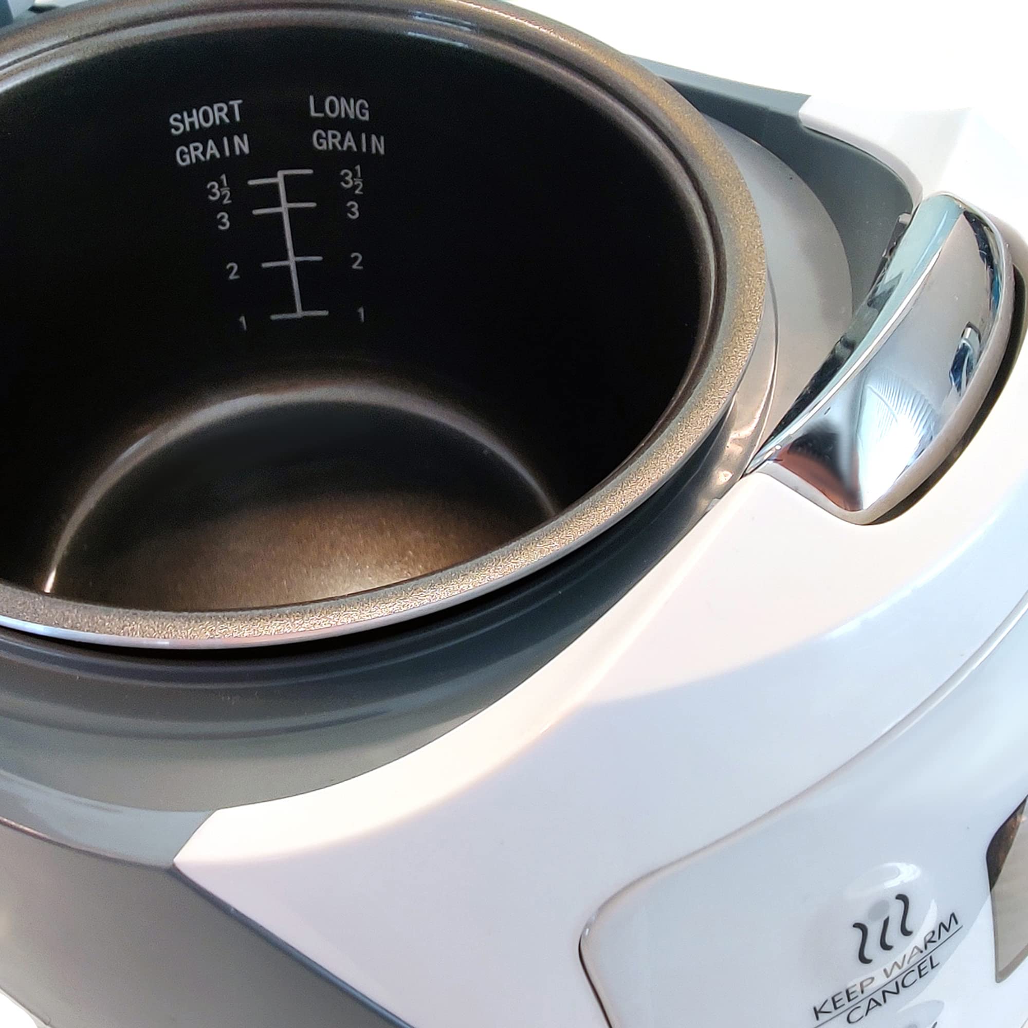 Yum Asia Panda Mini Rice Cooker measuring cup included for accurate portions.