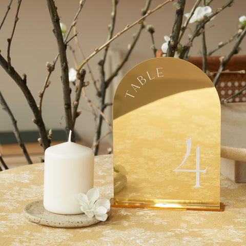 Close-up of ZICOTO gold arch design on table numbers as a luxe focal point.