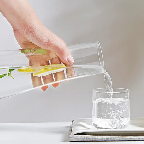 ZILJJ bedside glass carafe with tumbler lid on nightstand.
