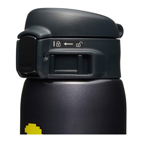 Zojirushi PAC-MAN mug lid demonstrates secure closure for travel.