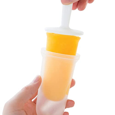 ZOKU Classic Pops pouring fruit juice into molds for fresh flavors.