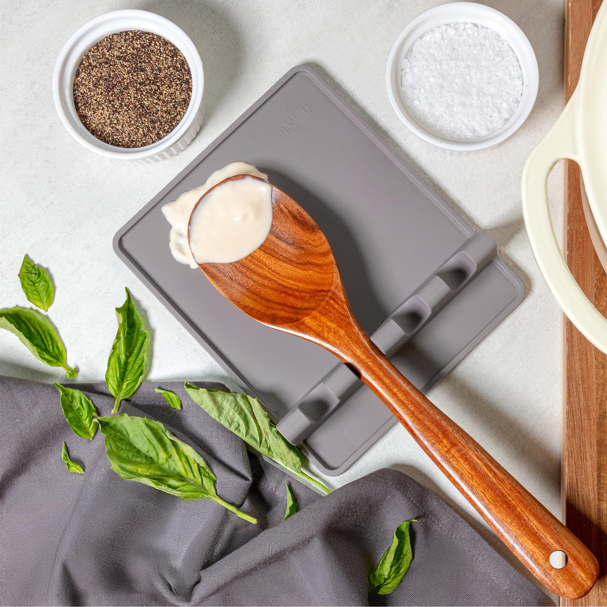 Countertop-friendly spoon holder that helps prevent splatter on surfaces.