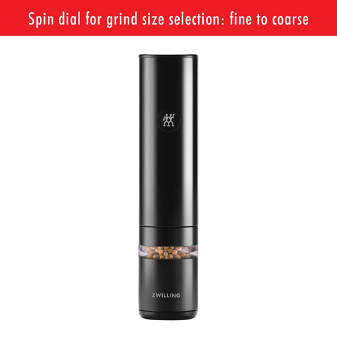 ZWILLING Enfinigy mill with automatic light guiding seasoning on countertop in dim light.