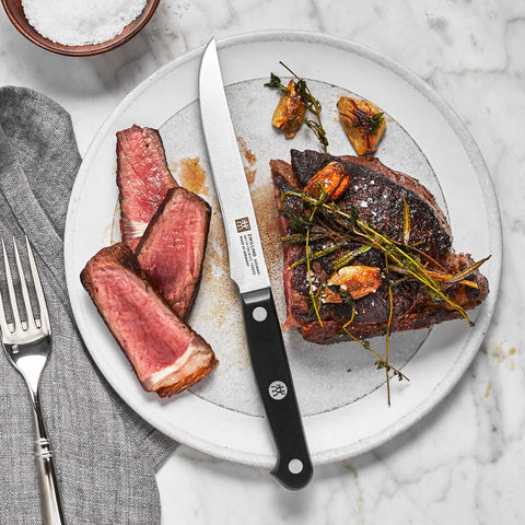 ZWILLING Gourmet 6pc steak knife set ergonomic handle detail for comfortable cutting.