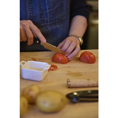 Zwilling Pro paring knife on cutting board for clean vegetable prep.