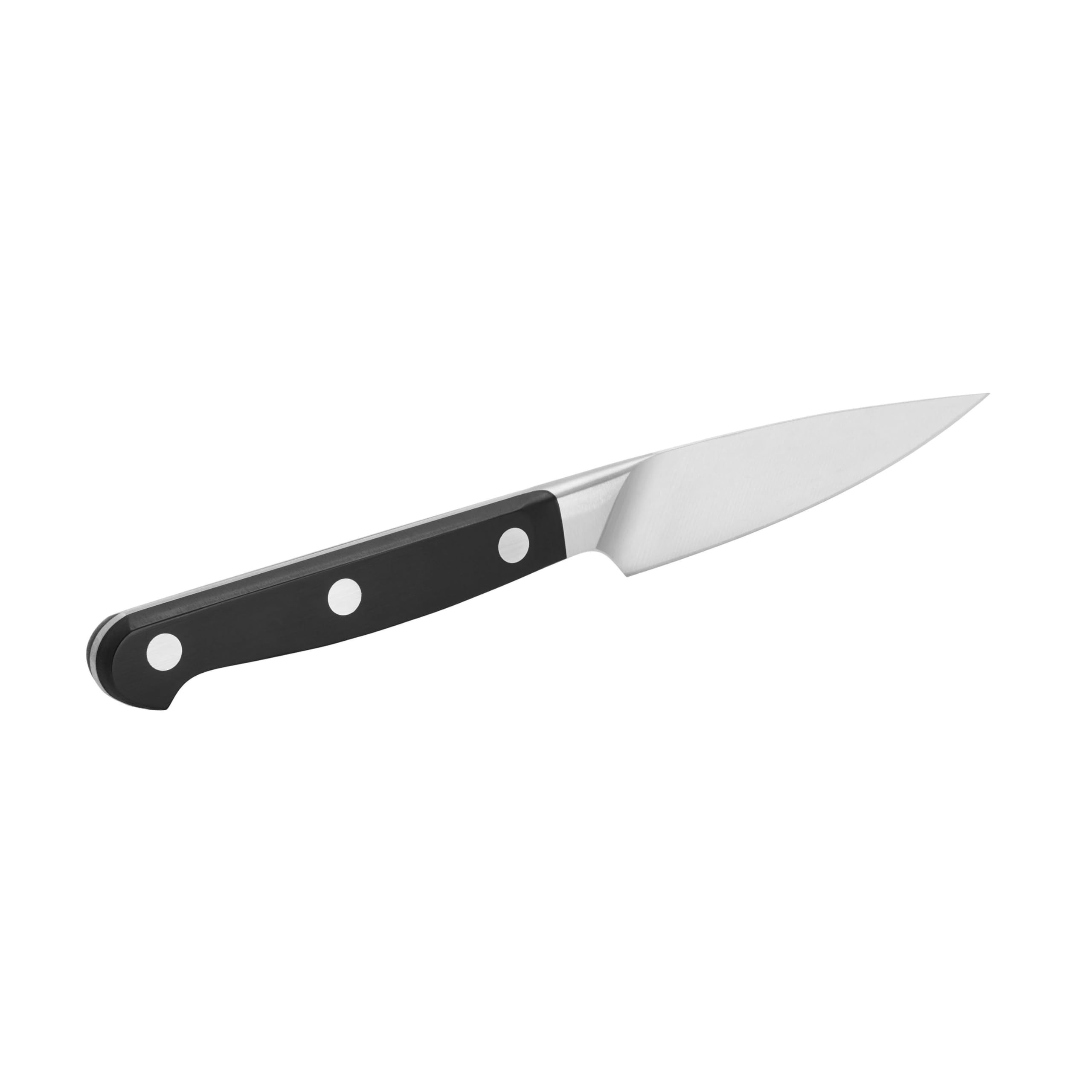 Zwilling Pro paring knife slicing small vegetables with accuracy.