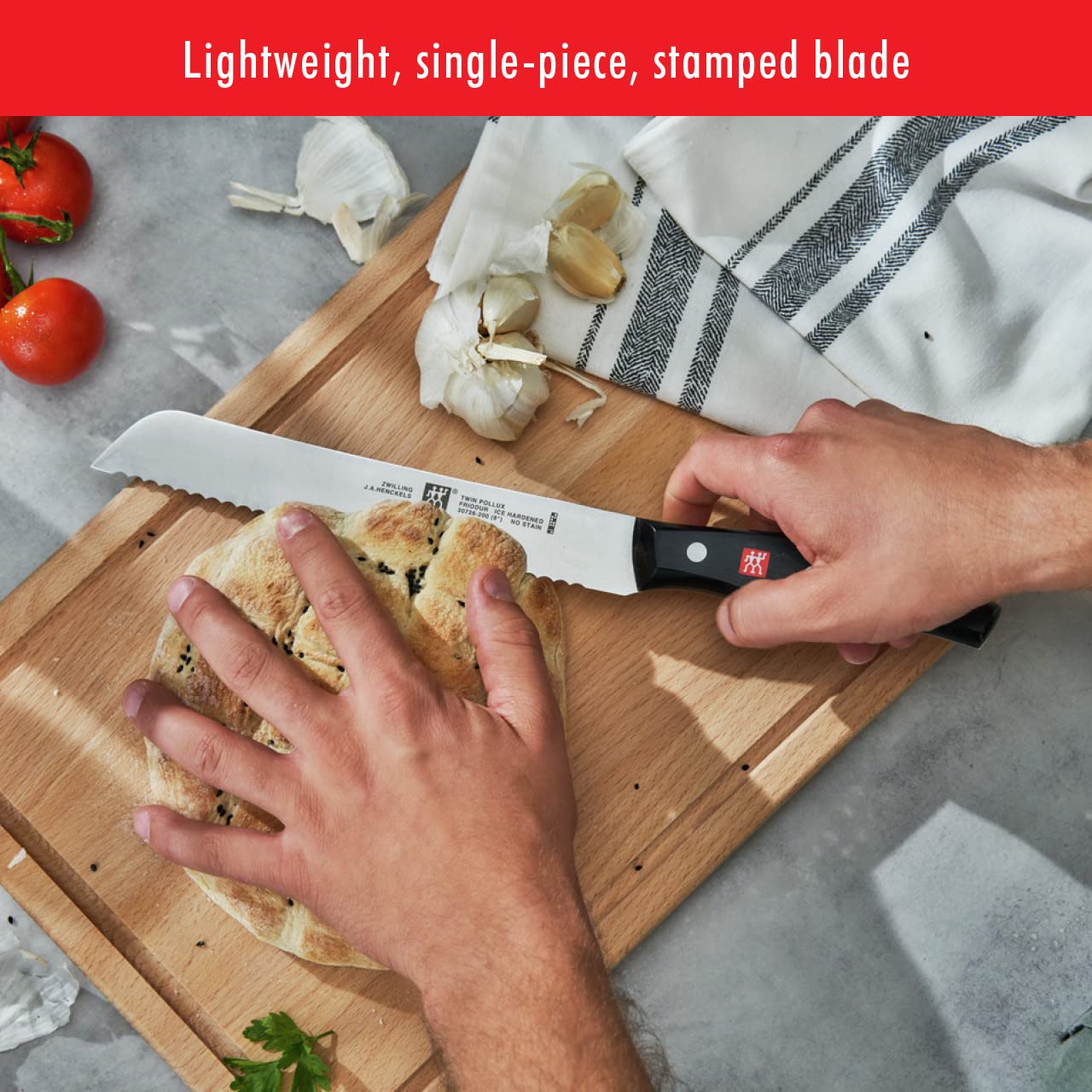 ZWILLING Twin Signature 8-inch bread knife in use slicing bread with ease.