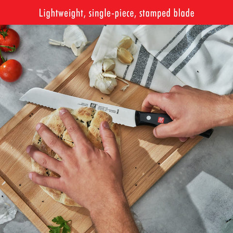 ZWILLING Twin Signature 8-inch bread knife in use slicing bread with ease.